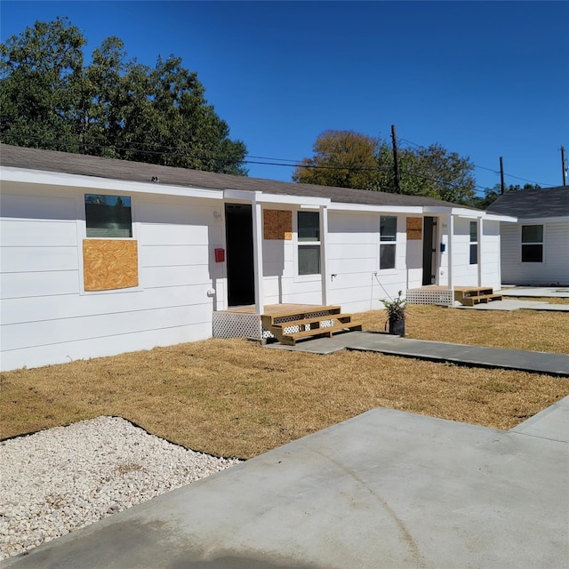 single story home with a front lawn and a patio area