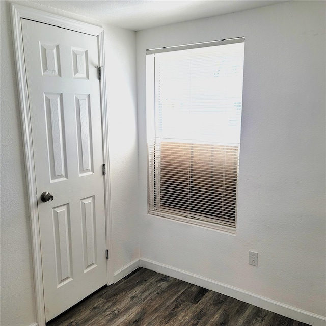 spare room with dark hardwood / wood-style floors