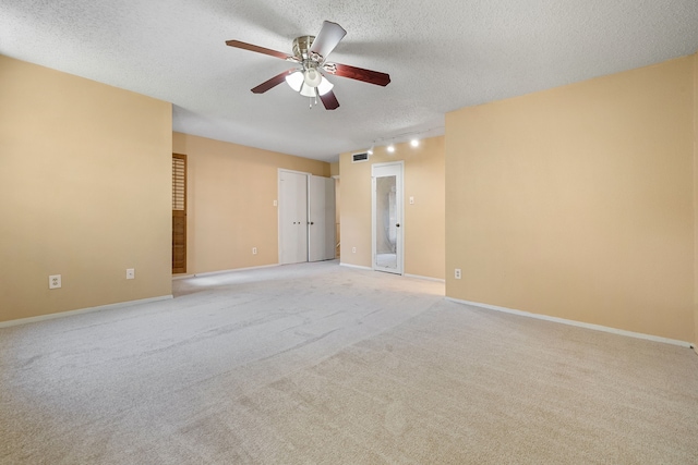 unfurnished room with light carpet, a textured ceiling, and ceiling fan