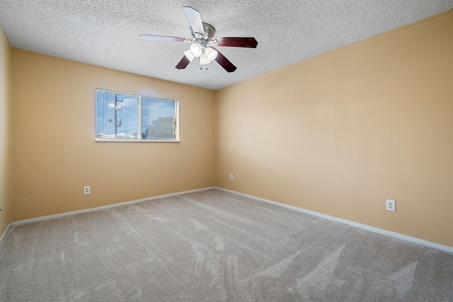 carpeted spare room with ceiling fan and a textured ceiling