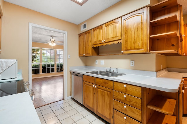 kitchen featuring stainless steel dishwasher, a textured ceiling, ceiling fan, sink, and light tile patterned floors