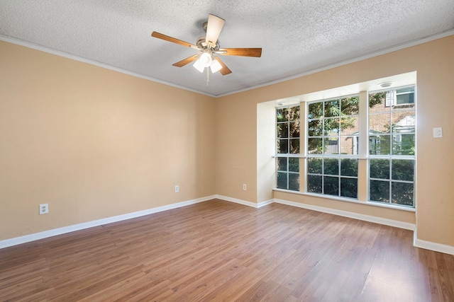 spare room with ceiling fan, ornamental molding, a textured ceiling, and hardwood / wood-style flooring