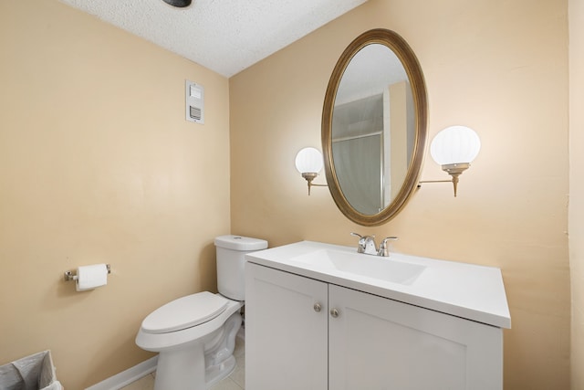 bathroom with vanity, a textured ceiling, and toilet