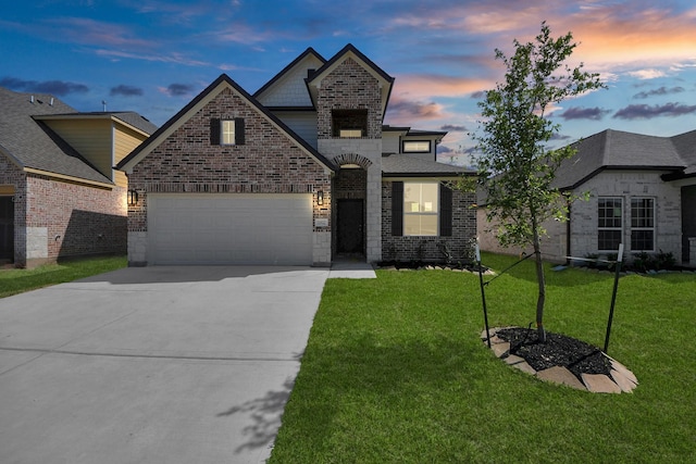 view of front of house with brick siding, a front lawn, and driveway