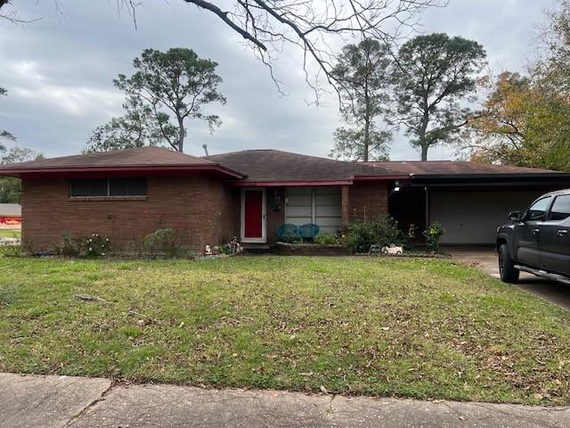 single story home with a front lawn and a garage