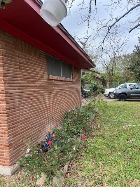 view of side of property with a yard