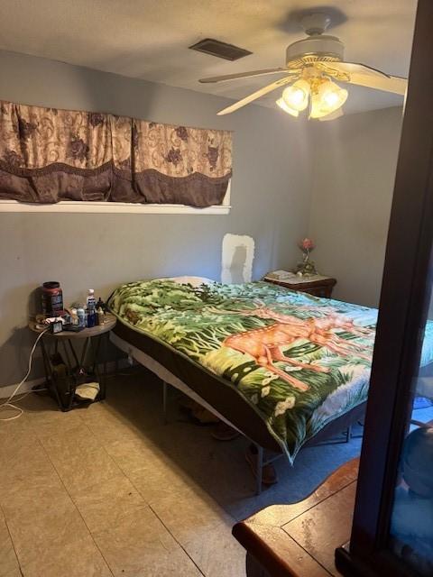 bedroom featuring ceiling fan and light tile patterned floors