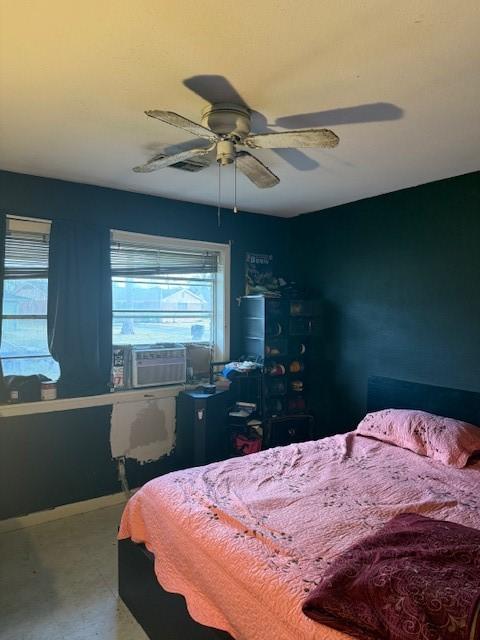 bedroom with cooling unit and ceiling fan