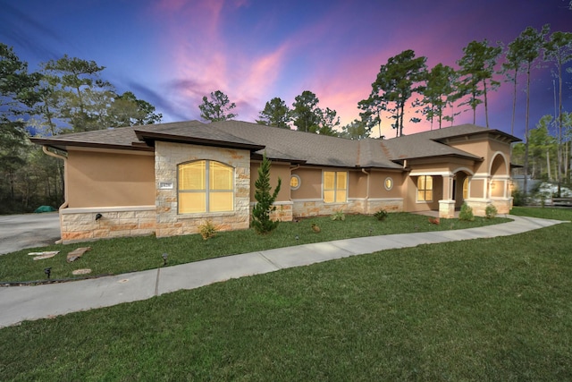 prairie-style house featuring a lawn