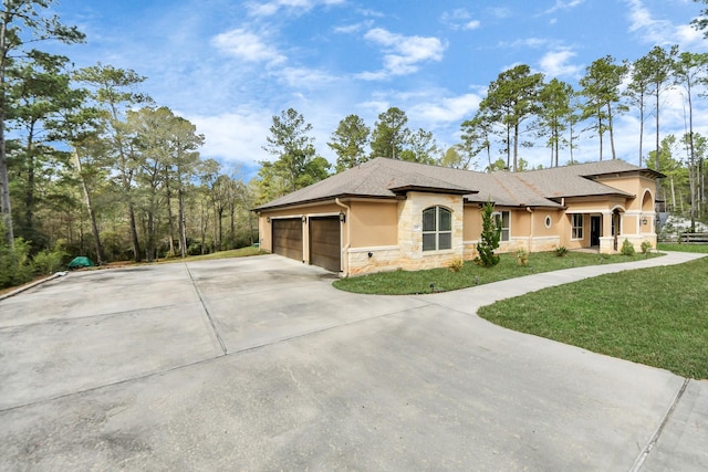 view of front of house with a garage and a front lawn