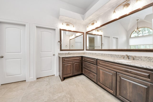 bathroom featuring vanity and vaulted ceiling