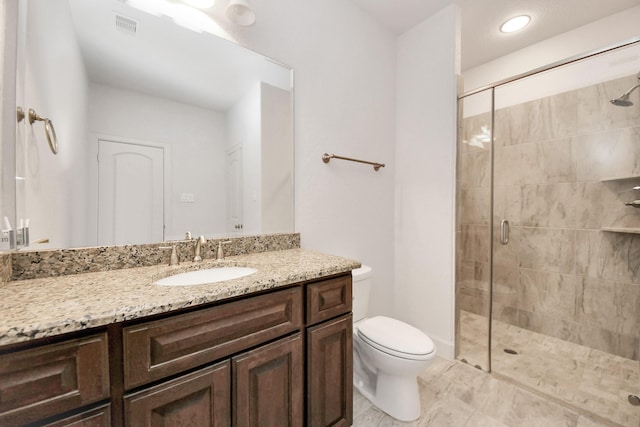 bathroom with toilet, walk in shower, and vanity