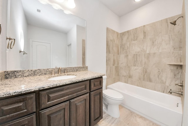 full bathroom with toilet, tiled shower / bath, and vanity