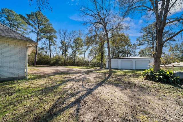 view of yard with a garage and an outdoor structure