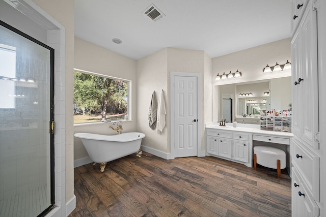 bathroom featuring separate shower and tub, hardwood / wood-style floors, and vanity