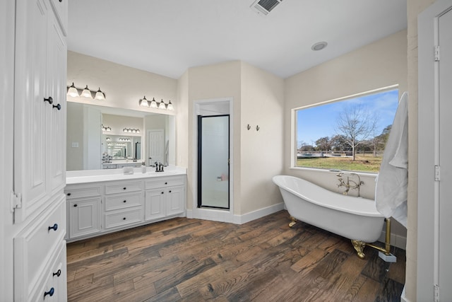 bathroom with vanity, wood-type flooring, and shower with separate bathtub