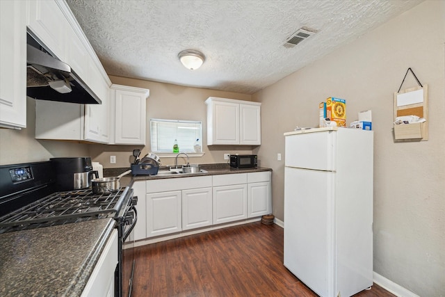 kitchen with black appliances, white cabinetry, sink, and a textured ceiling