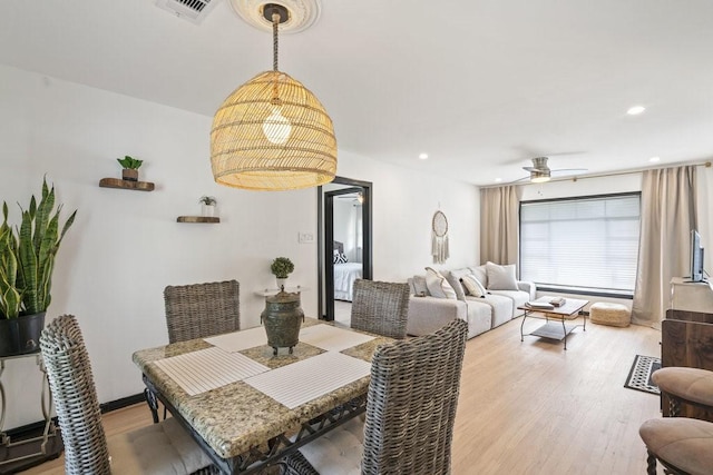 dining area featuring ceiling fan and light hardwood / wood-style flooring