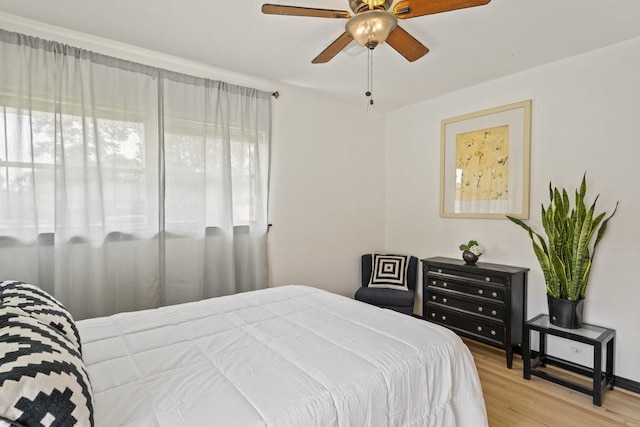 bedroom with hardwood / wood-style flooring and ceiling fan