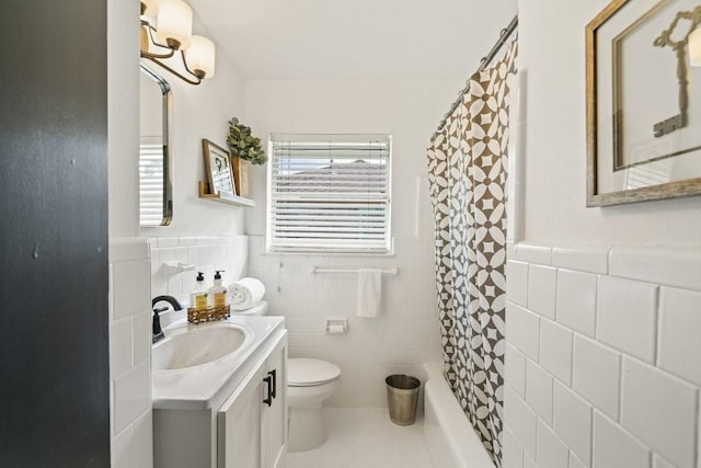 full bathroom with vanity, shower / bath combination with curtain, tile patterned flooring, toilet, and tile walls