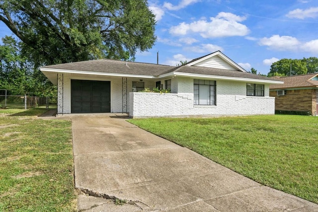 single story home with a garage and a front lawn