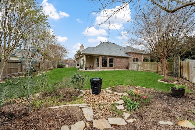 rear view of house featuring a patio area and a lawn