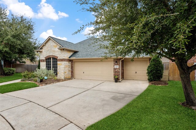 view of front of property with a front lawn and a garage