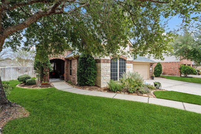 obstructed view of property featuring a front yard and a garage