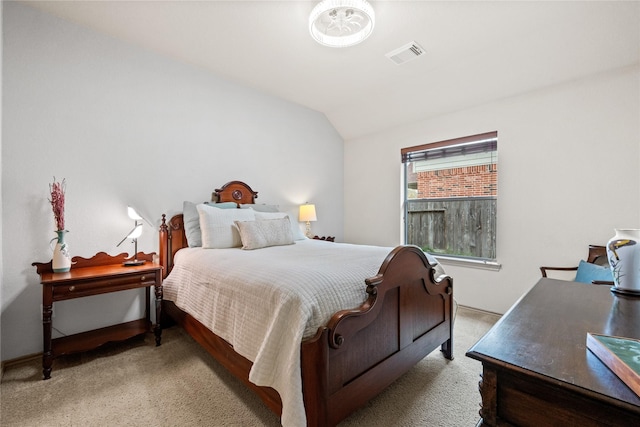 carpeted bedroom with lofted ceiling