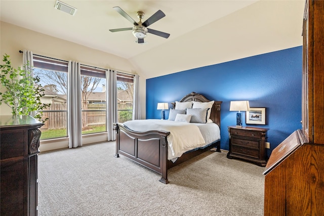 carpeted bedroom with vaulted ceiling and ceiling fan