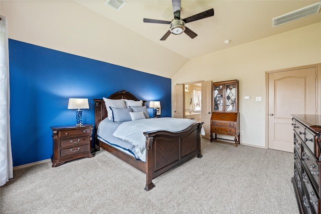 carpeted bedroom featuring lofted ceiling, connected bathroom, and ceiling fan