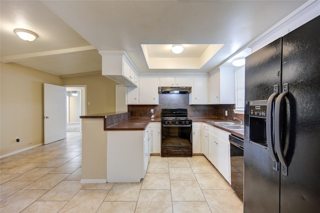 kitchen featuring white cabinetry, kitchen peninsula, decorative backsplash, light tile patterned floors, and black appliances