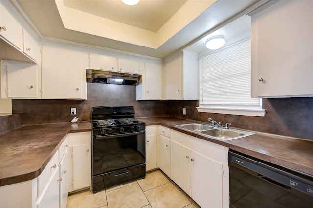 kitchen with a tray ceiling, sink, black appliances, white cabinets, and light tile patterned flooring