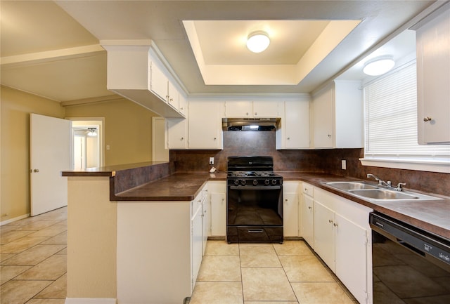 kitchen featuring black appliances, white cabinetry, and a tray ceiling