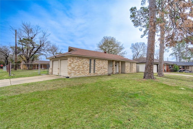 ranch-style house featuring a front yard and a garage