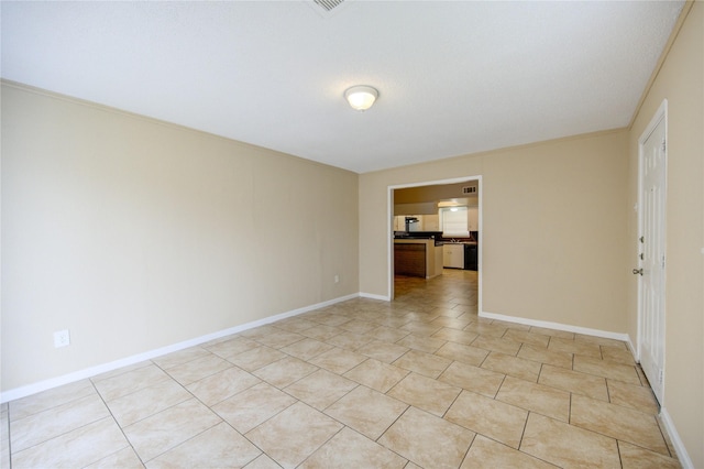 spare room featuring light tile patterned floors