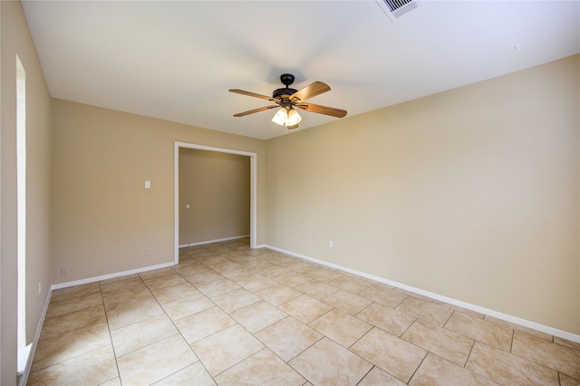 tiled spare room with ceiling fan