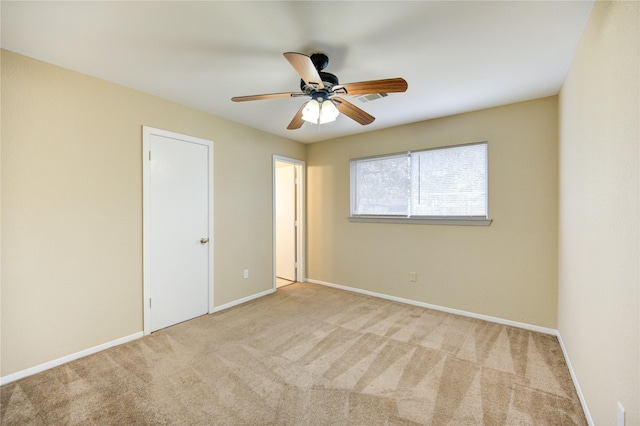 unfurnished room featuring ceiling fan and light colored carpet