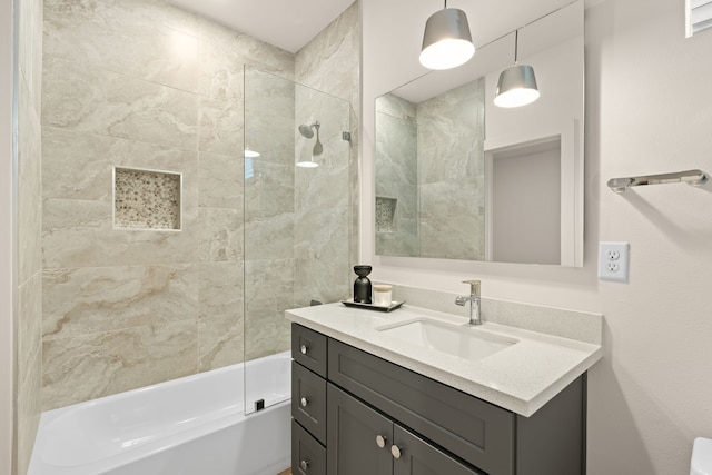 bathroom with vanity and tiled shower / bath