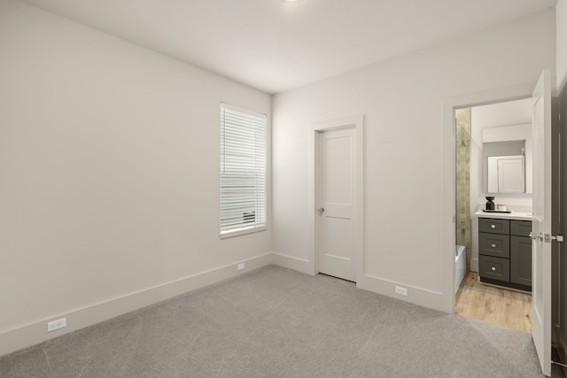 unfurnished bedroom with light colored carpet