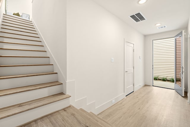 foyer entrance with light hardwood / wood-style floors