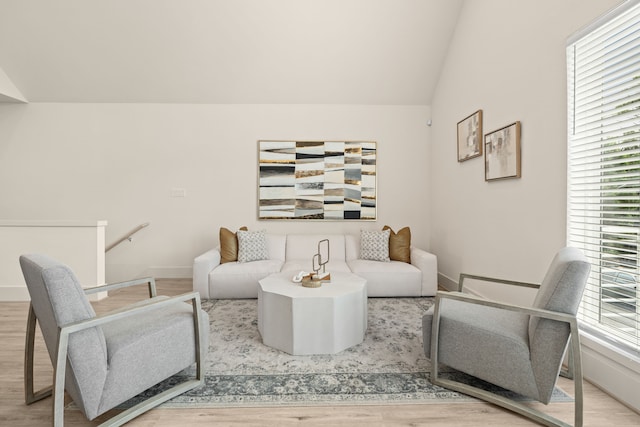 living room with lofted ceiling and light wood-type flooring