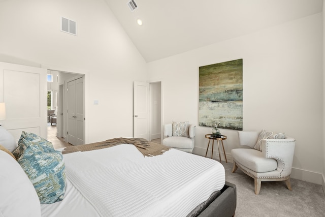 carpeted bedroom featuring high vaulted ceiling