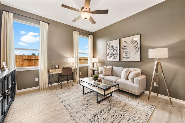 living room featuring ceiling fan and light hardwood / wood-style flooring