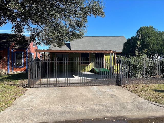 view of gate with a lawn