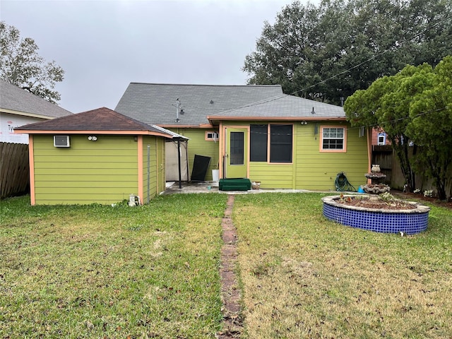 rear view of property featuring a yard