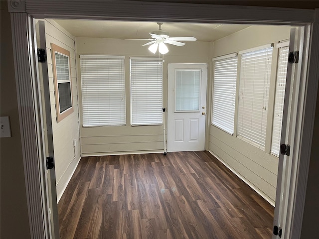 unfurnished sunroom featuring ceiling fan