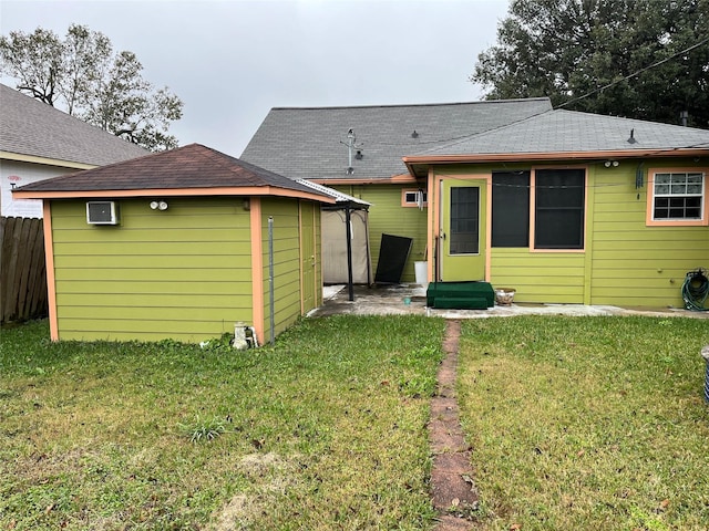 rear view of property featuring a lawn