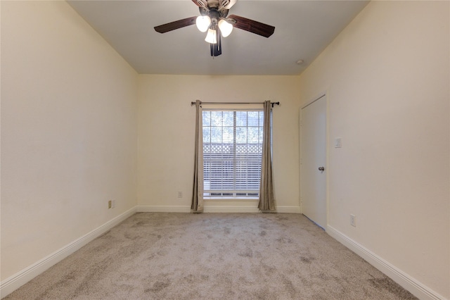 empty room featuring ceiling fan and light colored carpet