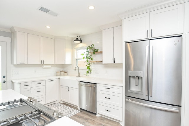 kitchen featuring white cabinetry, sink, and appliances with stainless steel finishes